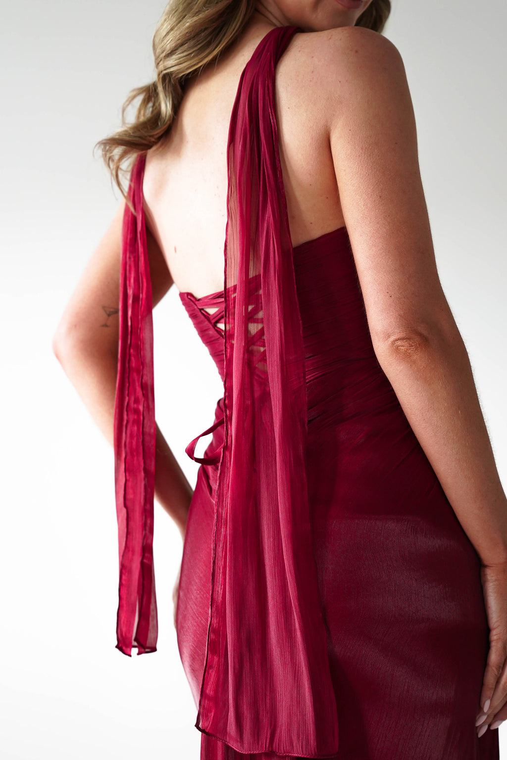Marielle Glowing Chiffon Strapless Maxi Dress in burgundy – hem detail | Velora premium burgundy dresses
