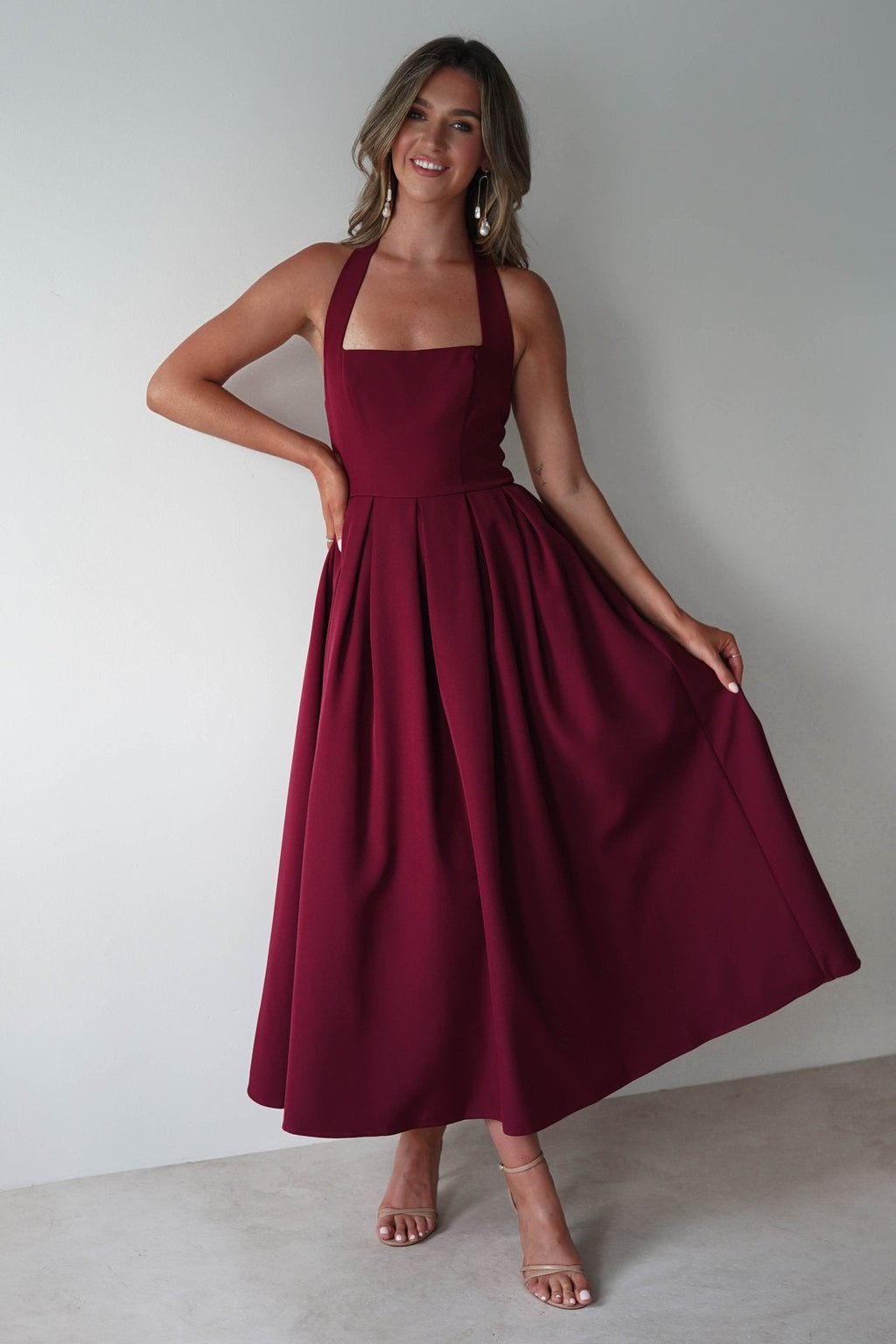 Daria Halter Neck Midi Dress in wine – styled with heels | Velora premium burgundy dresses