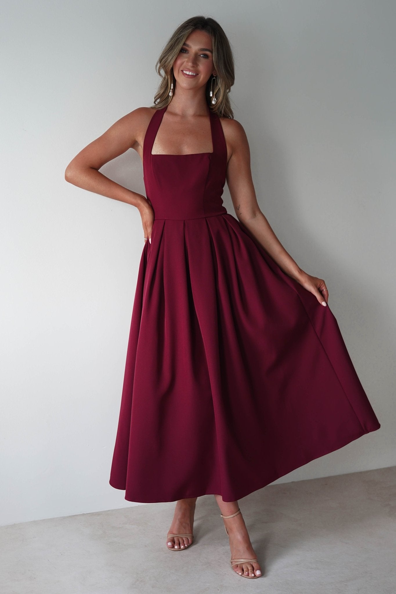 Daria Halter Neck Midi Dress in wine – styled with heels | Velora premium burgundy dresses