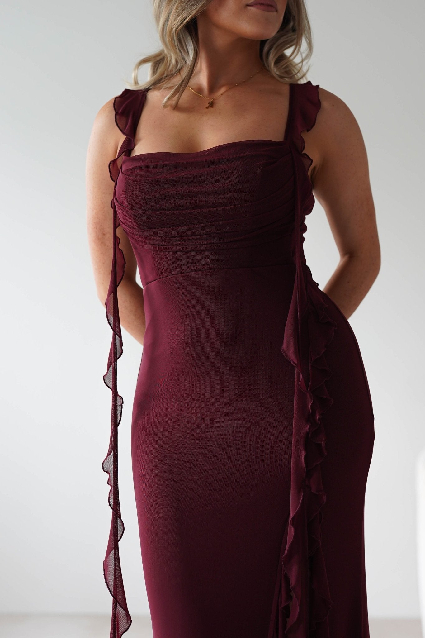 Mhissa Ruffle Maxi Dress in burgundy – styled with heels | Velora premium burgundy dresses